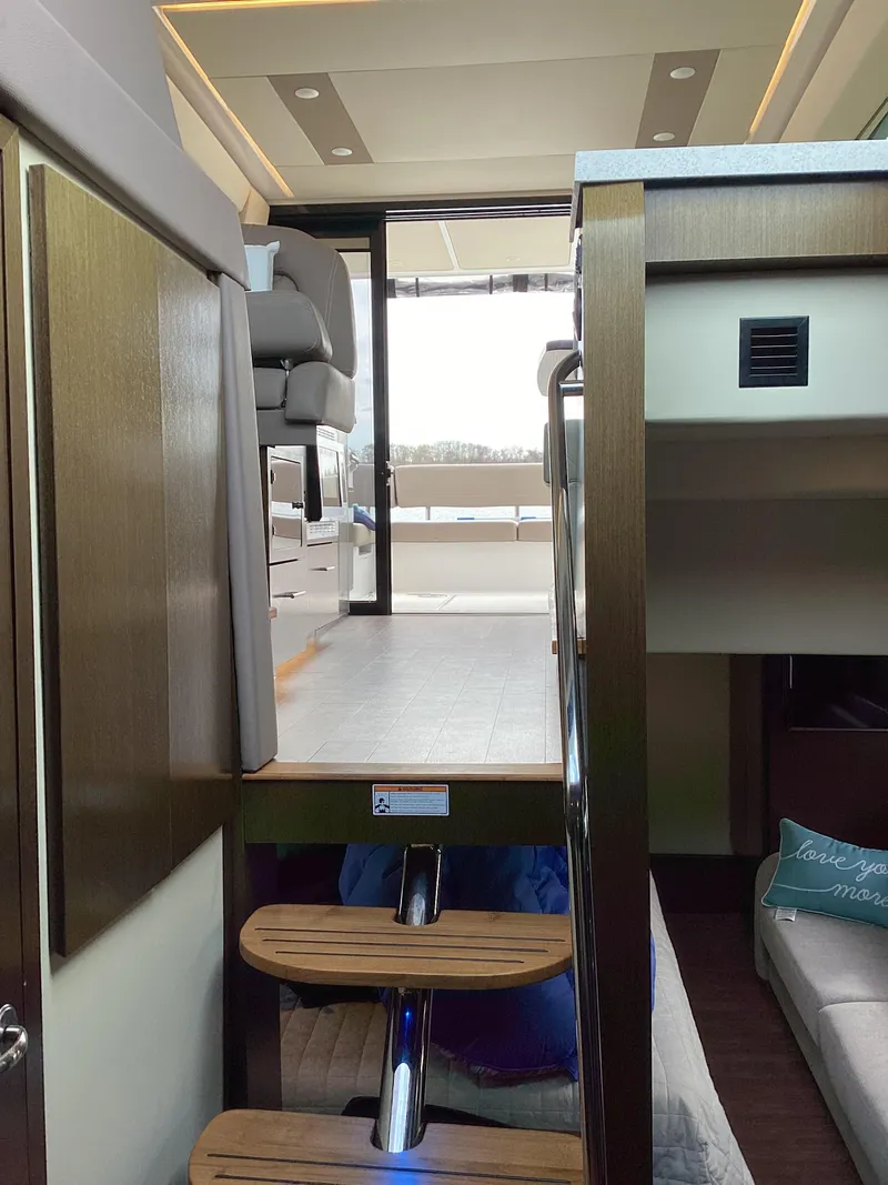 Slide: The Image of Interior view of 2018 Regal 42 Fly yacht, featuring modern design and wooden steps. - 14
