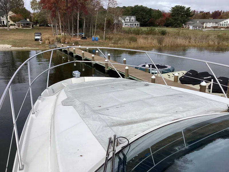 Slide: The Image of Regal 42 Fly 2018 yacht docked by a scenic lakeside pier. - 19