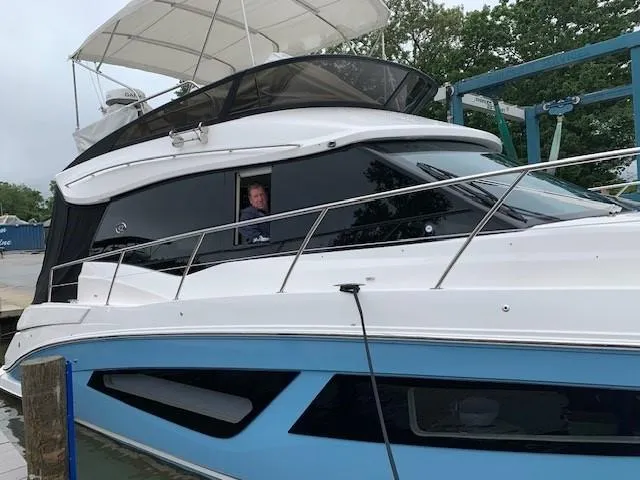 Slide: The Image of 2018 Regal 42 Fly yacht docked, featuring sleek design and modern amenities. - 2