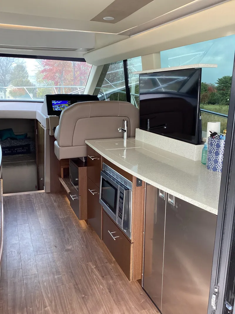 Slide: The Image of Interior of 2018 Regal 42 Fly yacht with modern kitchen and navigation area. - 32