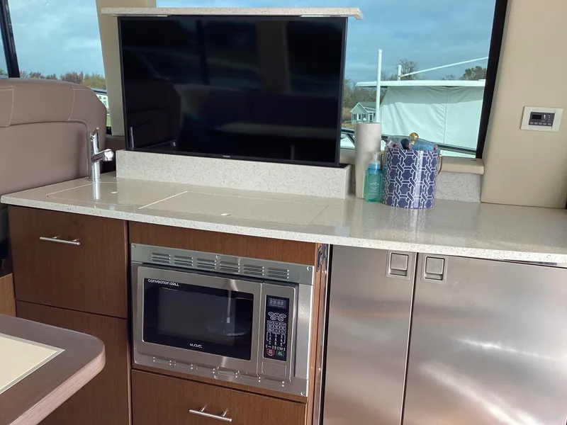 Slide: The Image of Modern kitchen area in 2018 Regal 42 Fly yacht with microwave and TV. - 33