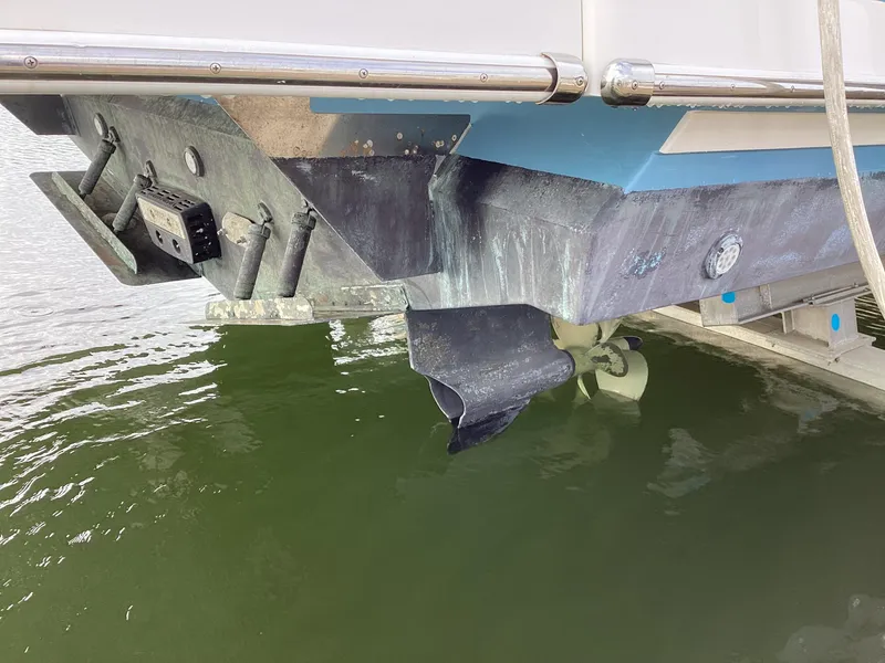 Slide: The Image of 2018 Regal 42 Fly boat stern view with propeller and rudder in water. - 35