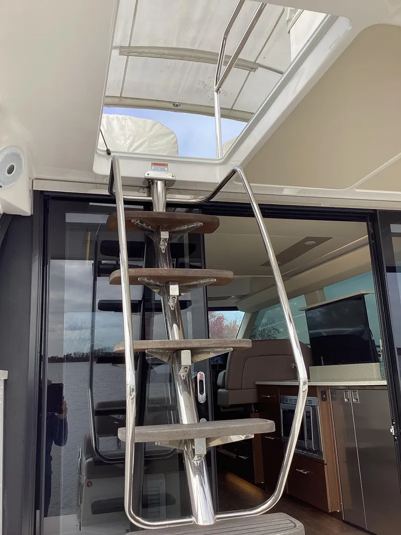 Slide: The Image of Stainless steel staircase on 2018 Regal 42 Fly yacht, leading to upper deck. - 38