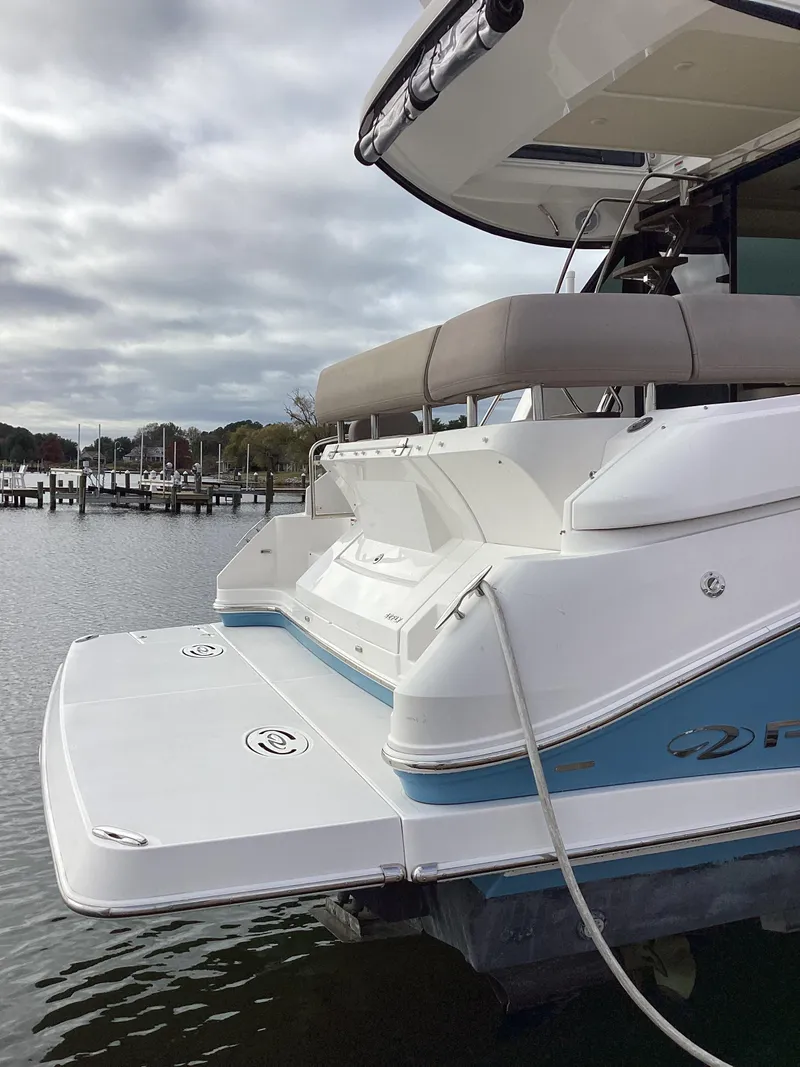 Slide: The Image of 2018 Regal 42 Fly yacht docked by the water on a cloudy day. - 40