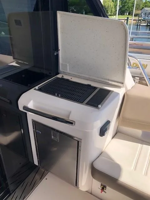 Slide: The Image of Outdoor grill on 2018 Regal 42 Fly yacht, featuring stainless steel finish and storage compartment. - 45