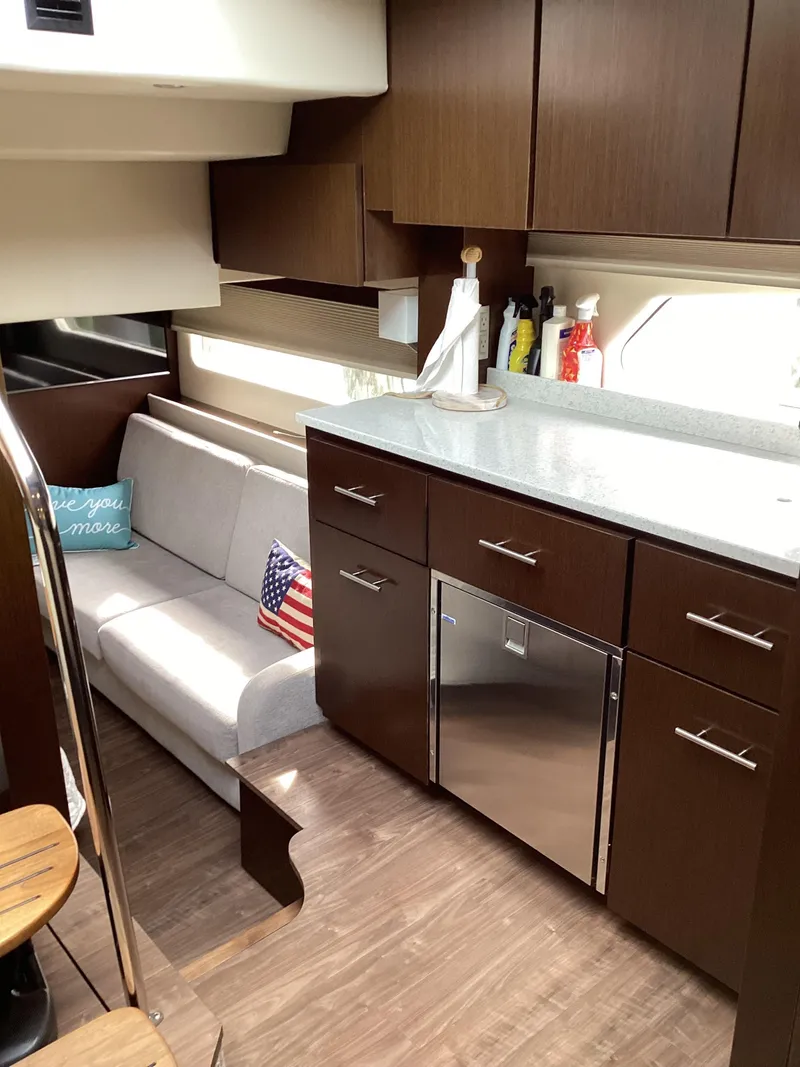 Slide: The Image of Luxurious interior of 2018 Regal 42 Fly yacht with modern kitchen and cozy seating area. - 7