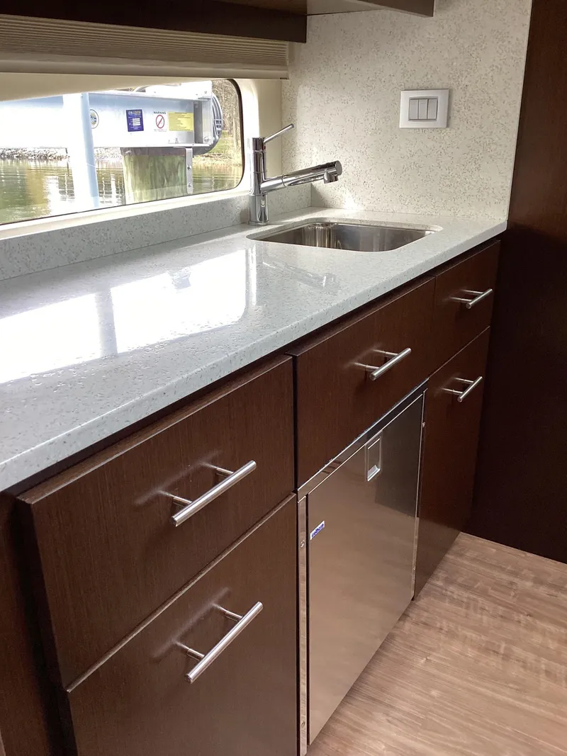 Slide: The Image of Modern kitchen in 2018 Regal 42 Fly yacht with sleek cabinetry and stainless steel sink. - 8