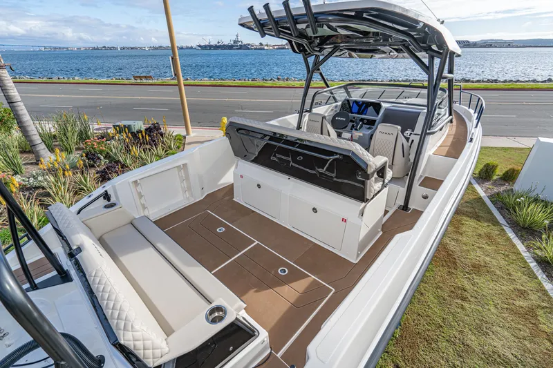 Slide: The Image of Navan S30 2025 boat with spacious deck, luxurious seating, and modern design by the waterfront. - 15