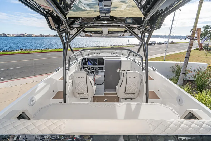 Slide: The Image of 2025 Navan S30 boat interior with dual seats, overlooking a scenic waterfront. - 17