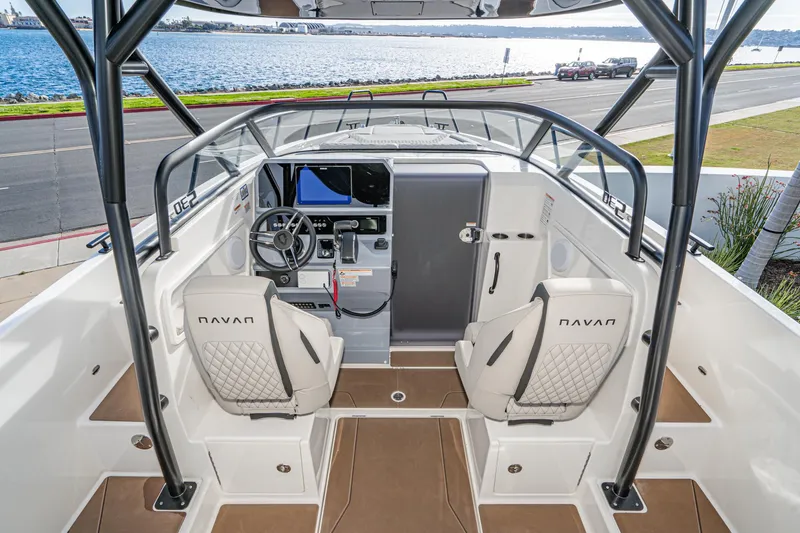 Slide: The Image of 2025 Navan S30 boat interior with modern helm, dual seats, and waterfront view. - 18