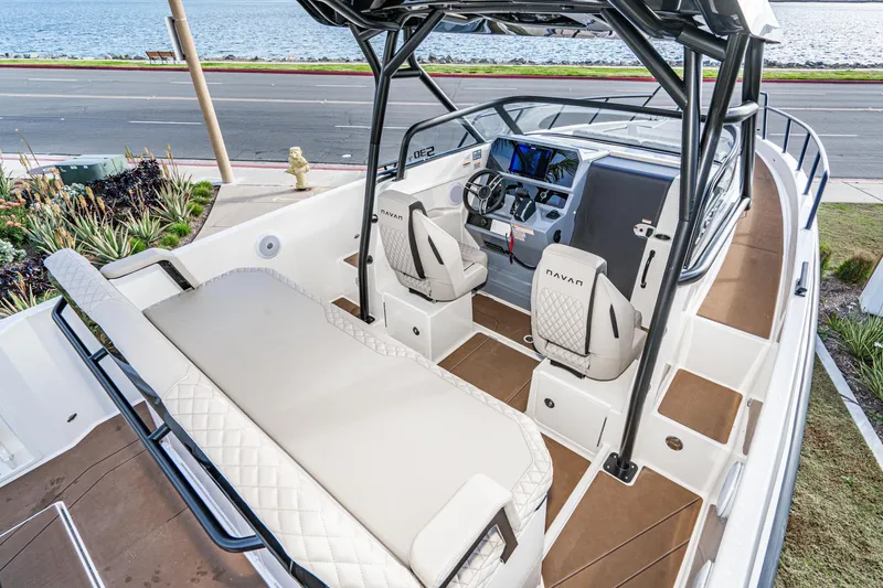 Slide: The Image of 2025 Navan S30 boat interior with modern seating and sleek dashboard, near waterfront. - 20