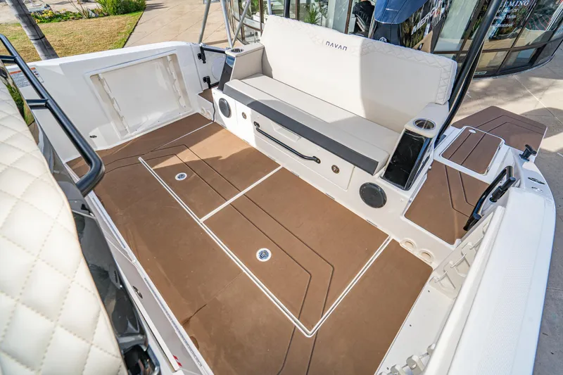 Slide: The Image of 2025 Navan S30 boat interior with cushioned seating and brown deck flooring. - 32