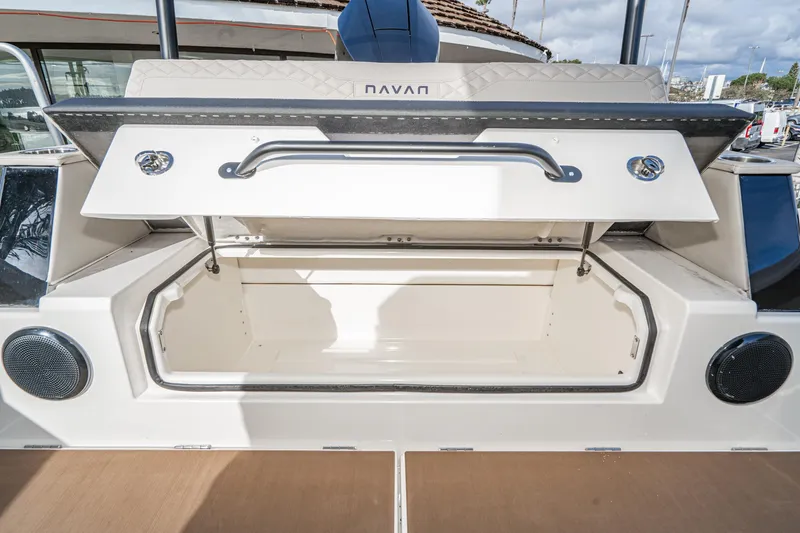 Slide: The Image of Open storage compartment on a 2025 Navan S30 boat, featuring sleek design and speakers. - 33