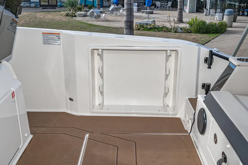 Slide: The Image of Navan S30 2025 boat interior with storage compartment and brown flooring. - 35