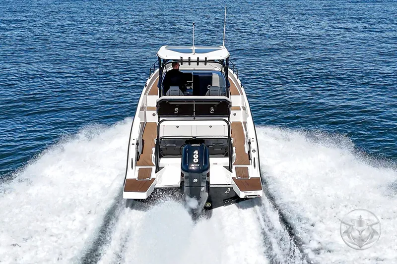 Slide: The Image of Navan S30 2025 boat cruising on open water, rear view. - 6