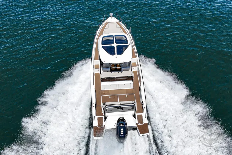 Slide: The Image of Navan S30 2025 boat cruising on open water, aerial view. - 7