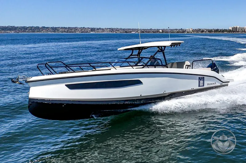 Slide: The Image of Navan S30 2025 boat cruising on open water under clear blue sky. - 9