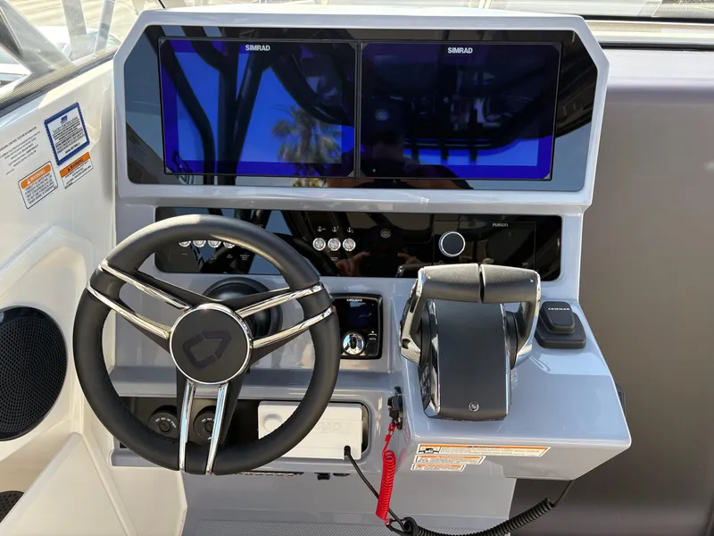 Slide: The Image of Navan S30 2025 boat dashboard with steering wheel, dual Simrad displays, and control panel. - 11