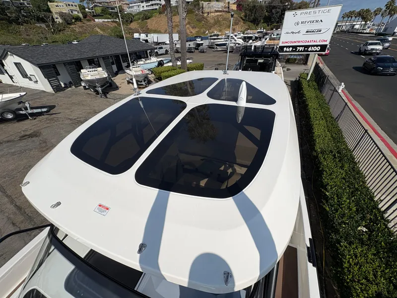 Slide: The Image of Navan S30 2025 boat with sunroof, parked at a marina dealership. - 8