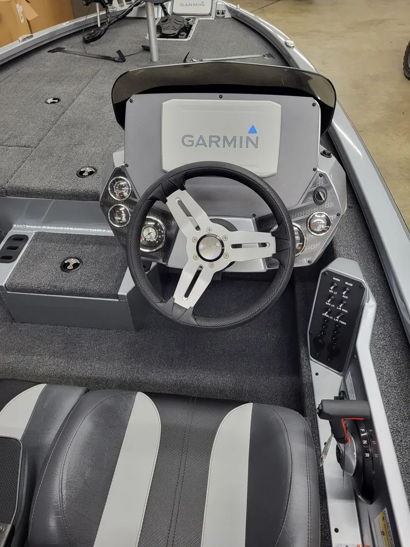 Slide: The Image of 2023 Vexus AVX1880 boat cockpit with Garmin display and steering wheel. - 13