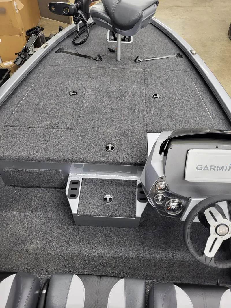 Slide: The Image of 2023 Vexus AVX1880 boat interior with Garmin system and gray carpeted deck. - 15