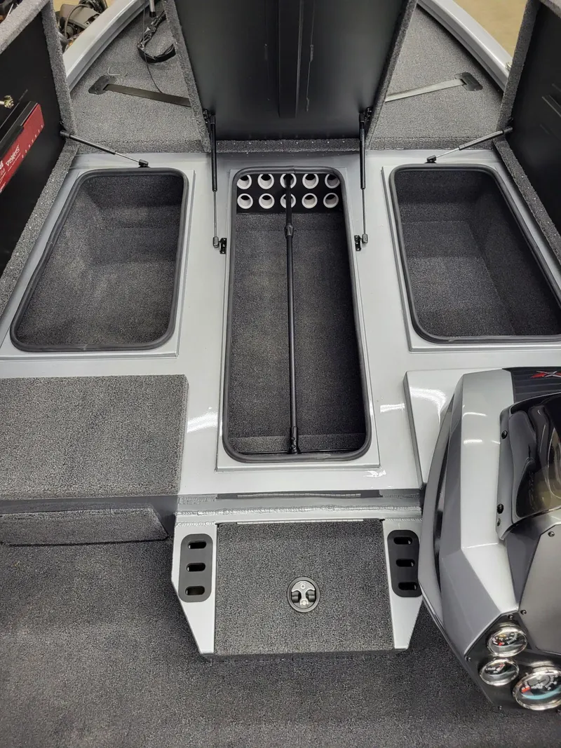 Slide: The Image of 2023 Vexus AVX1880 boat interior with open storage compartments and rod holders. - 17