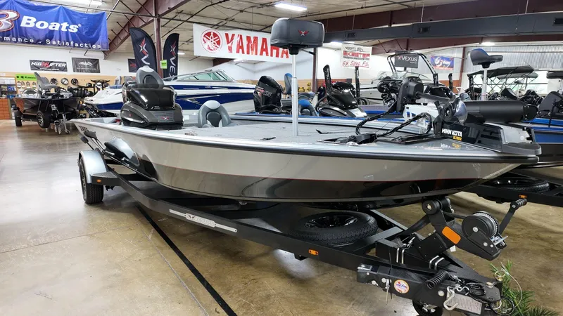 Slide: The Image of 2023 Vexus AVX1880 boat displayed in showroom with Yamaha signage. - 2