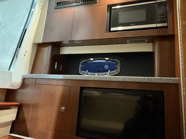 Slide: The Image of 2021 Chaparral 347 SSX interior with microwave and cabinetry. - 20