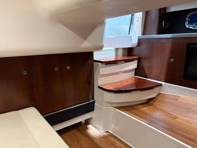 Slide: The Image of Interior of 2021 Chaparral 347 SSX boat with wooden steps and cabinetry. - 21