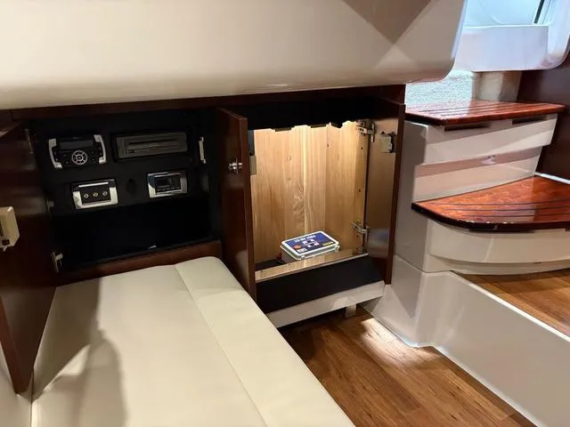 Slide: The Image of 2021 Chaparral 347 SSX cabin interior with storage compartments and wooden flooring. - 22
