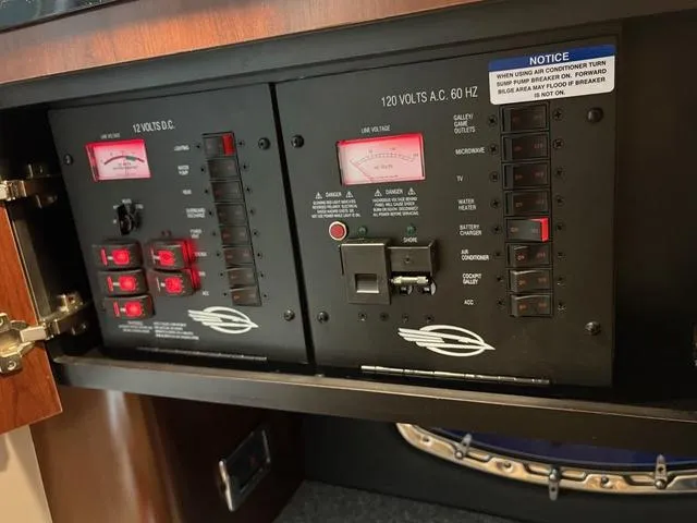 Slide: The Image of Electrical control panel on a 2021 Chaparral 347 SSX boat, featuring voltage meters and switches. - 23