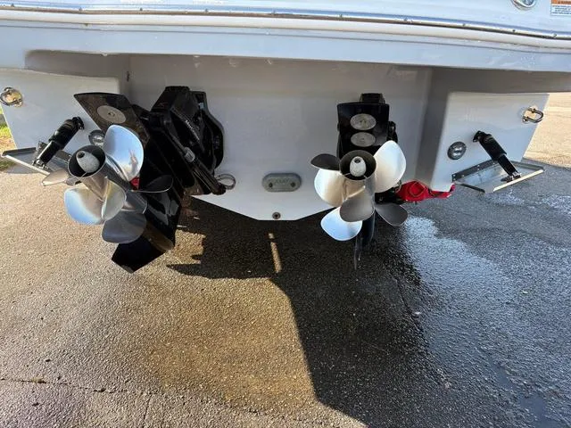 Slide: The Image of 2021 Chaparral 347 SSX boat stern with dual propellers on a wet surface. - 28
