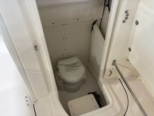 Slide: The Image of 2024 Robalo R250 boat interior with compact marine toilet. - 8