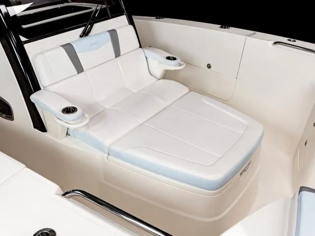 Slide: The Image of 2024 Robalo R360 boat interior with luxurious white seating and cup holders. - 3