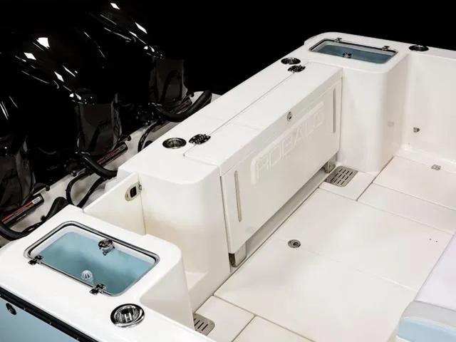 Slide: The Image of 2024 Robalo R360 boat deck with storage compartments and sleek design. - 6