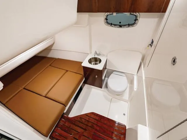Slide: The Image of 2024 Robalo R360 cabin interior with bed, sink, and toilet. - 8