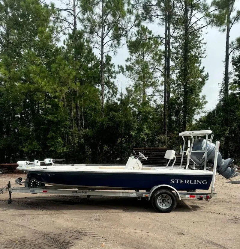 The Image of 2005 Sterling 180TS boat on trailer, parked outdoors near trees. - 1