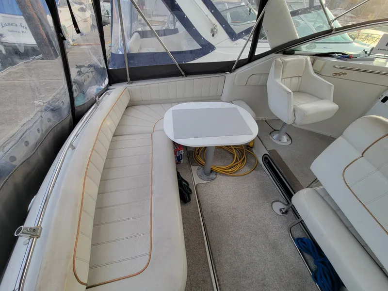 Slide: The Image of 1997 Larson 290 Cabrio boat interior with seating and table. - 13