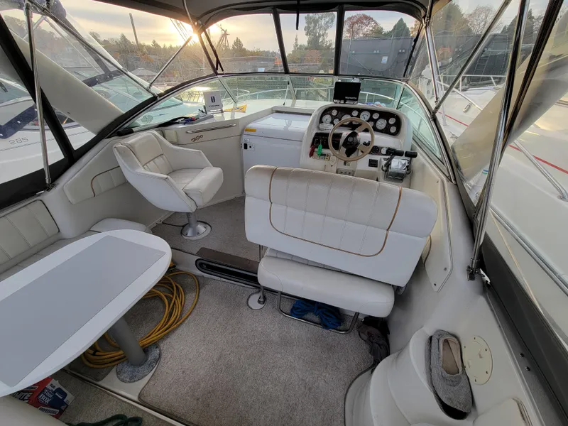 Slide: The Image of Interior of a 1997 Larson 290 Cabrio boat with seating and helm. - 14