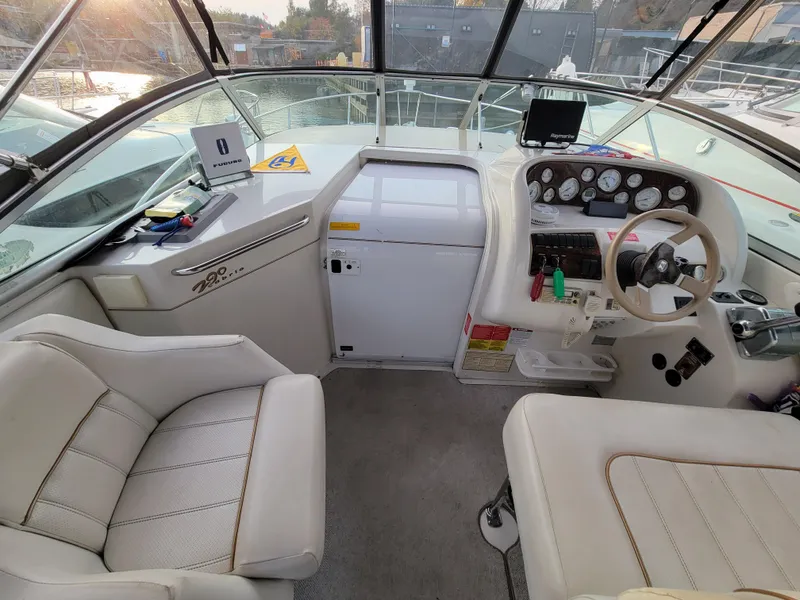 Slide: The Image of Interior of 1997 Larson 290 Cabrio boat with steering wheel and dashboard controls. - 15