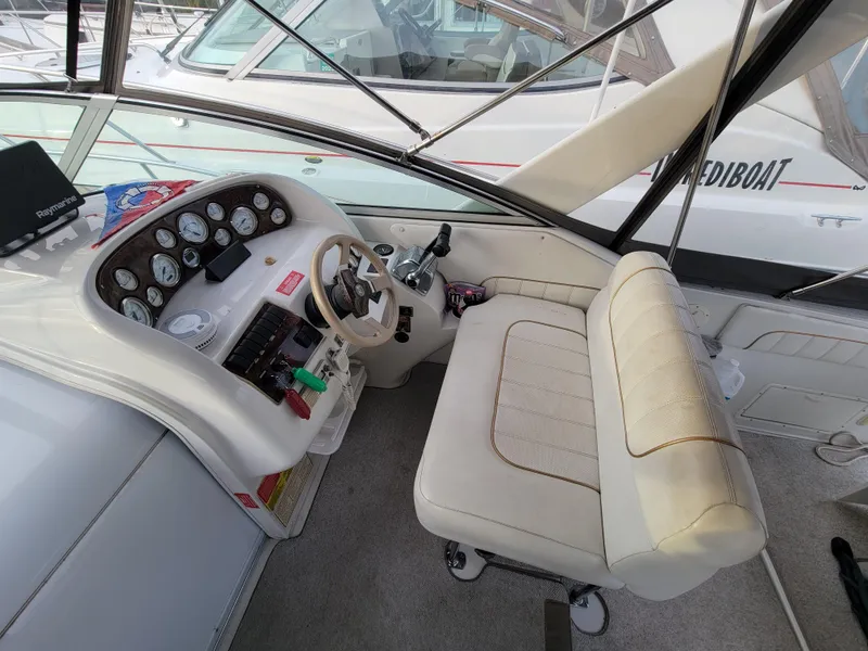Slide: The Image of 1997 Larson 290 Cabrio boat cockpit with steering wheel and control panel. - 17