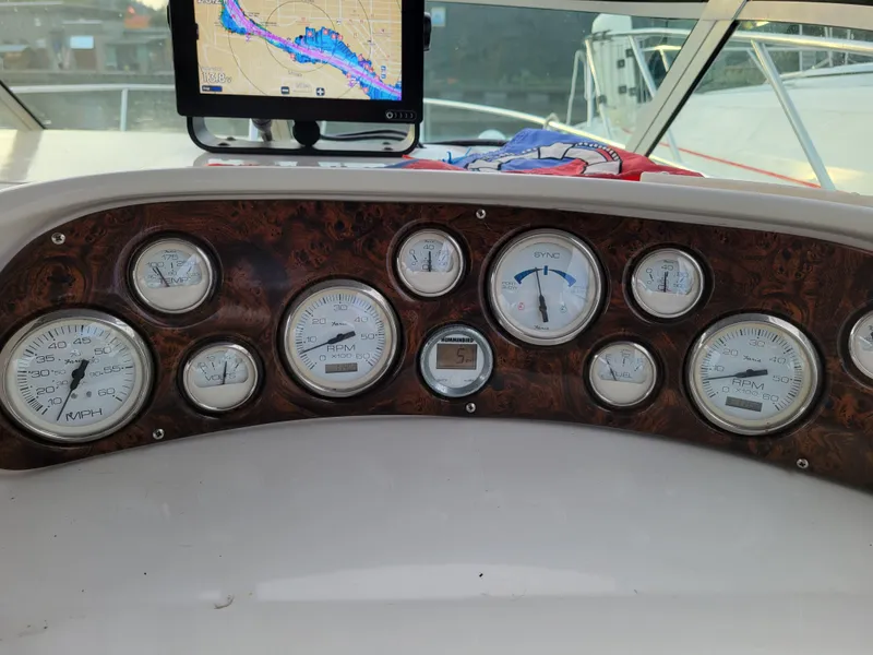 Slide: The Image of Dashboard of a 1997 Larson 290 Cabrio boat with gauges and navigation screen. - 19