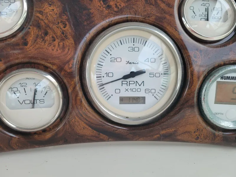 Slide: The Image of 1997 Larson 290 CABRIO dashboard with RPM and volt gauges. - 20