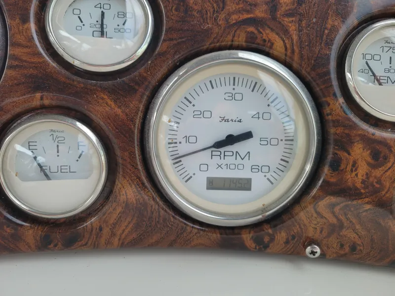 Slide: The Image of Dashboard gauges of a 1997 Larson 290 Cabrio boat, featuring RPM and fuel indicators. - 21