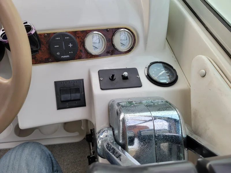 Slide: The Image of 1997 Larson 290 Cabrio boat dashboard with controls and gauges. - 23