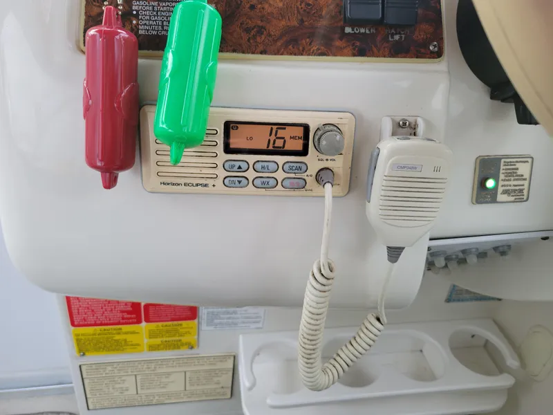 Slide: The Image of 1997 Larson 290 Cabrio boat dashboard with radio and microphone. - 26