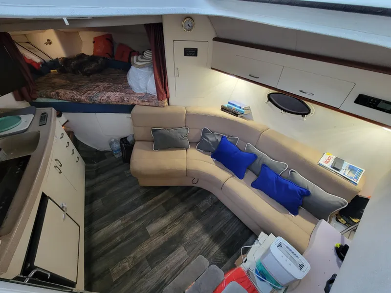 Slide: The Image of Interior of 1997 Larson 290 Cabrio boat with cozy seating and modern amenities. - 28