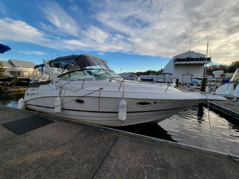 Slide: The Image of 1997 Larson 290 Cabrio boat docked at marina under blue sky. - 3