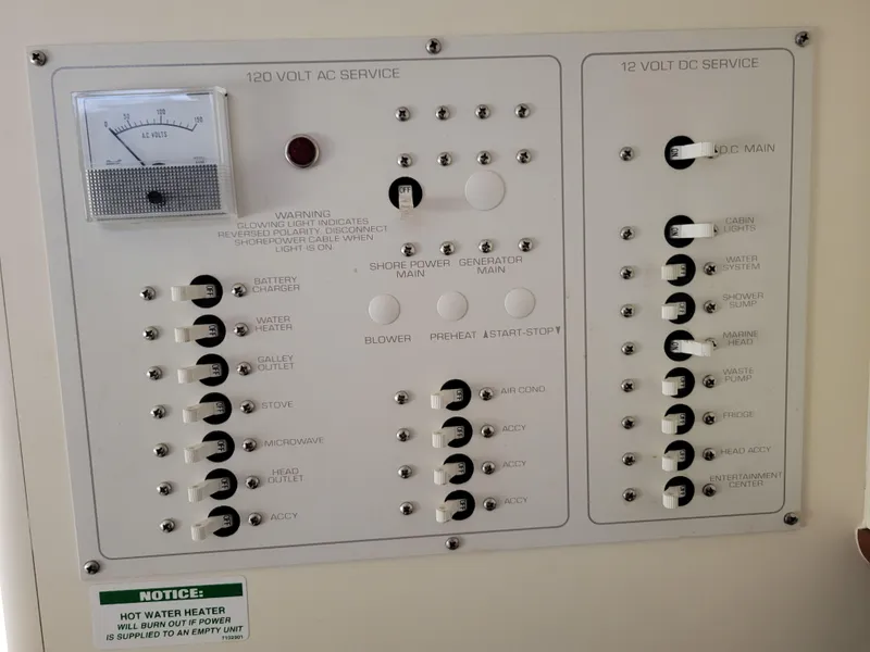 Slide: The Image of Control panel of a 1997 Larson 290 Cabrio boat, featuring AC and DC service switches. - 36