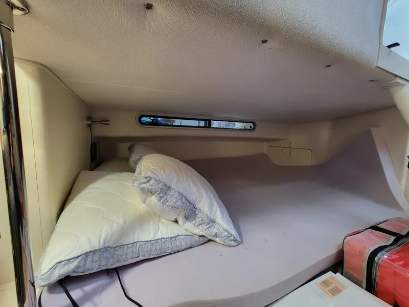 Slide: The Image of Cozy cabin interior of 1997 Larson 290 Cabrio with pillows and window. - 41